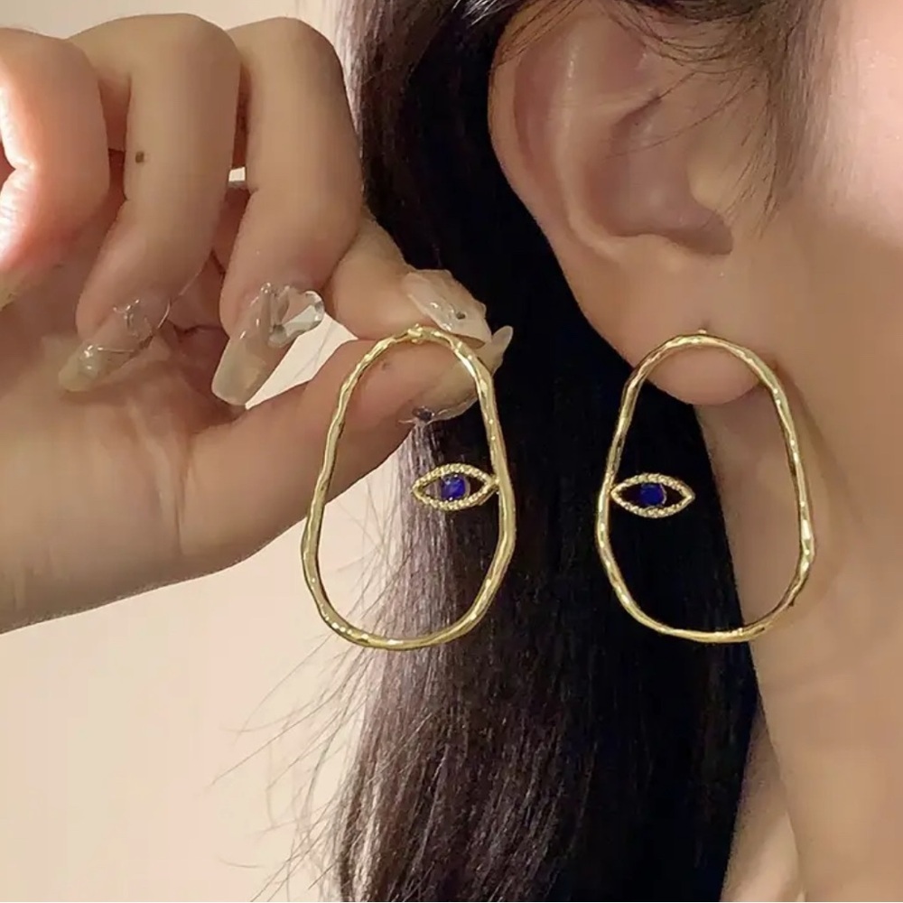 Stamped Gold tone oval earrings with subtle Evil eye Earrings